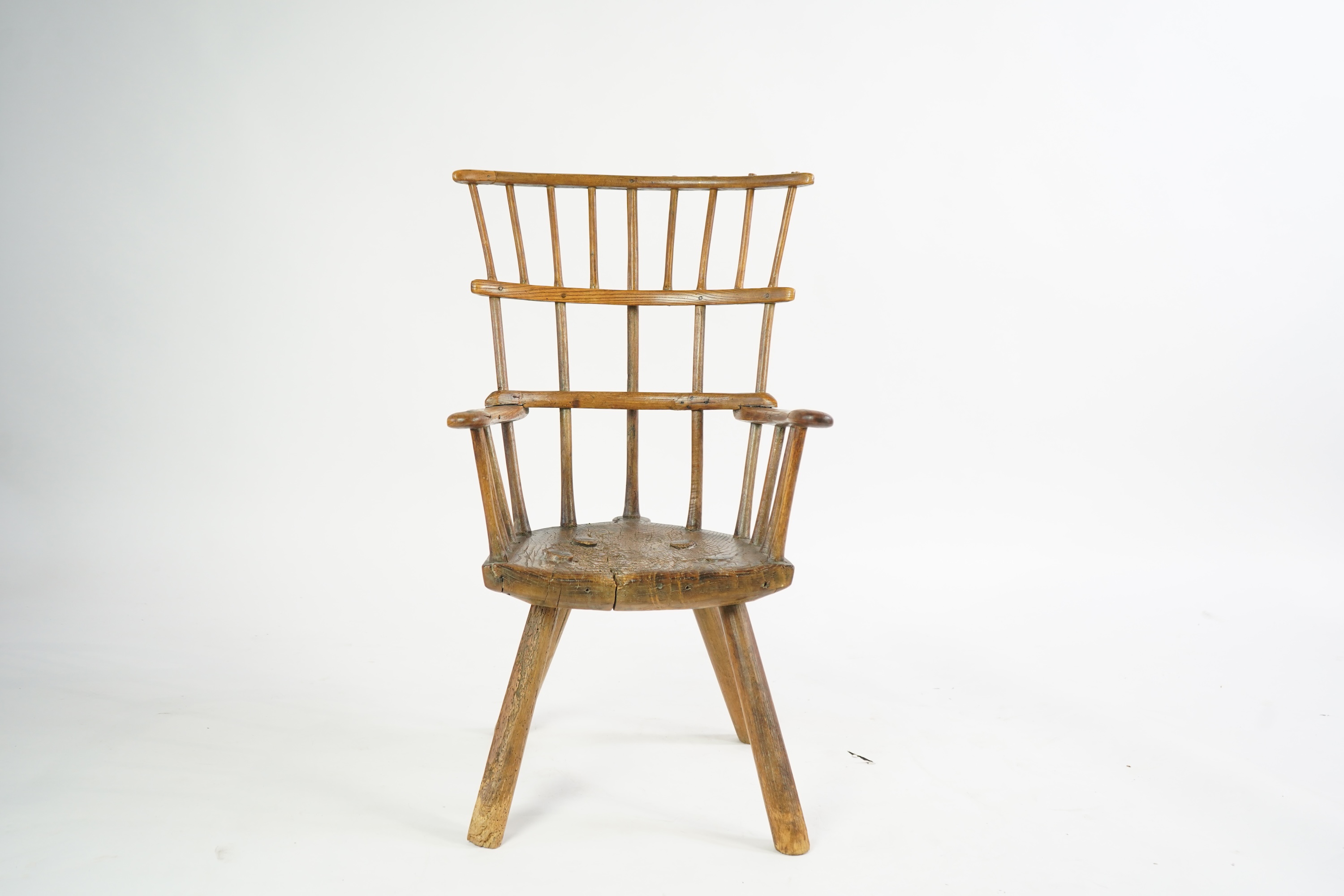 An 18th or 19th century primitive ash and elm Windsor armchair